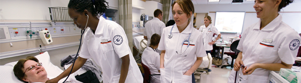 Image of nursing students in clinical setting with patient